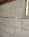 Severely buckling foundation walls in a home in Mexico in need of repairs.