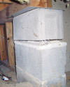 Concrete crawl space support posts in Moberly that are showing signs of failure as they sink into the earth.