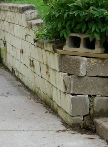 collapsing retaining wall with severe damage in Prairie Village