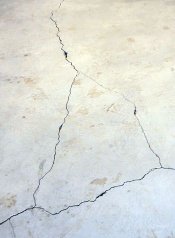 severely cracked, heaving slab floors in a home in Excelsior Springs