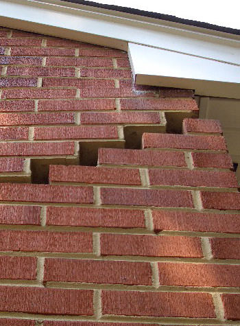 photo of a rotating foundation wall with cracks in Harrisonville
