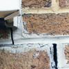 Failed crack repair showing old tuckpointing that cracked on a Columbia home.