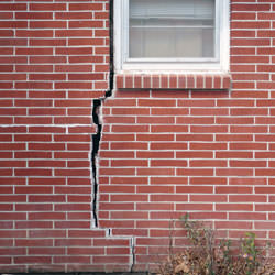 A foundation with a large crack that's wider at the top than on the bottom in Harrisonville