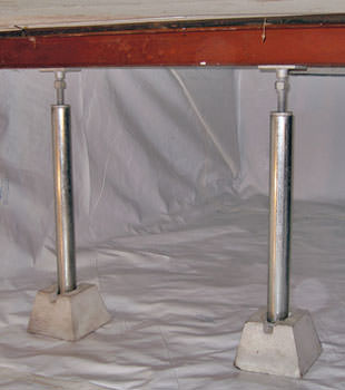 Crawl space jack posts installed in conjunction with a crawl space vapor barrier in Harrisonville