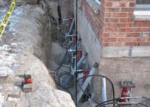 Foundation push piers installed around a house with a foundation settlement issues in Centralia