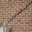 stair step cracking reaching from a window along the foundation wall in Columbia