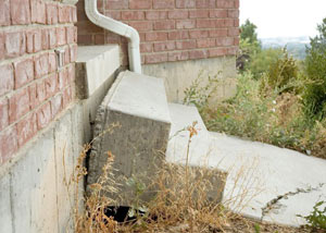 A sinking front step and cracked concrete sidewalk in Independence.