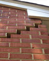 Serious damage to a foundation wall due to settlement of a home in Harrisonville