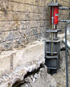 A completed installation of foundation push piers lifting a foundation in Kirksville