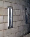 an inside view of foundation wall anchors installed along a basement wall to brace and repair the structure in Warrensbur